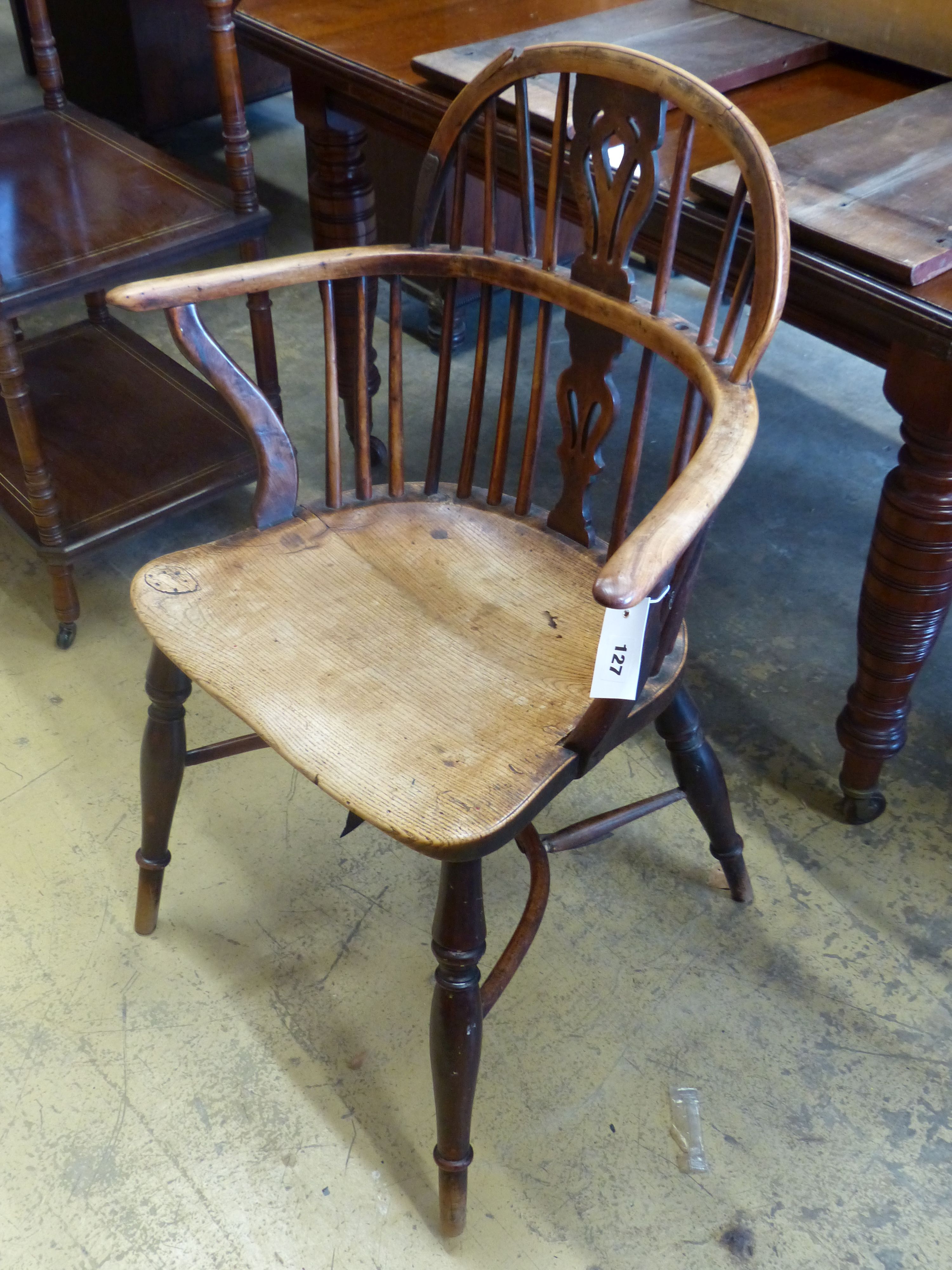An early 19th century yew and elm Windsor kitchen elbow chair